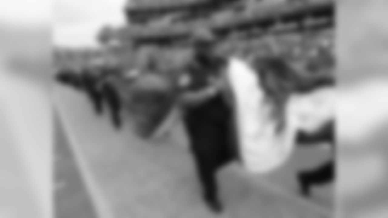 A Metro Nashville Police officer helps to carry a flag onto the field before an NFL football game between the Tennessee Titans and the Houston Texans Sunday, Sept. 16, 2018, in Nashville, Tenn. (AP Photo/Mark Zaleski)