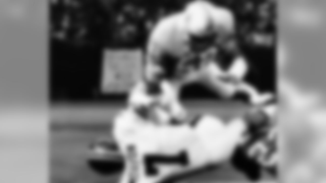 FILE - In this Dec. 5, 1977 file photo Denver Broncos' quarterback Craig Morton (7) tries to get set for the crunching blow from Houston Oilers' Robert Brazile (52) in the second quarter of their NFL football game in Houston. Though Brazile turned in his Dr. Doom persona decades ago for the role of Mr. Brazile, a special education teacher, he'll revisit the success of his first career on Saturday, Aug. 4, 2018 when he'll be one of eight men inducted into the Pro Football Hall of Fame. Brazile is part of a class which includes Bobby Beathard, Brian Dawkins, Jerry Kramer, Ray Lewis, Randy Moss, Brian Urlacher and Terrell Owens. (AP Photo/Ed Kolenovsky, file)