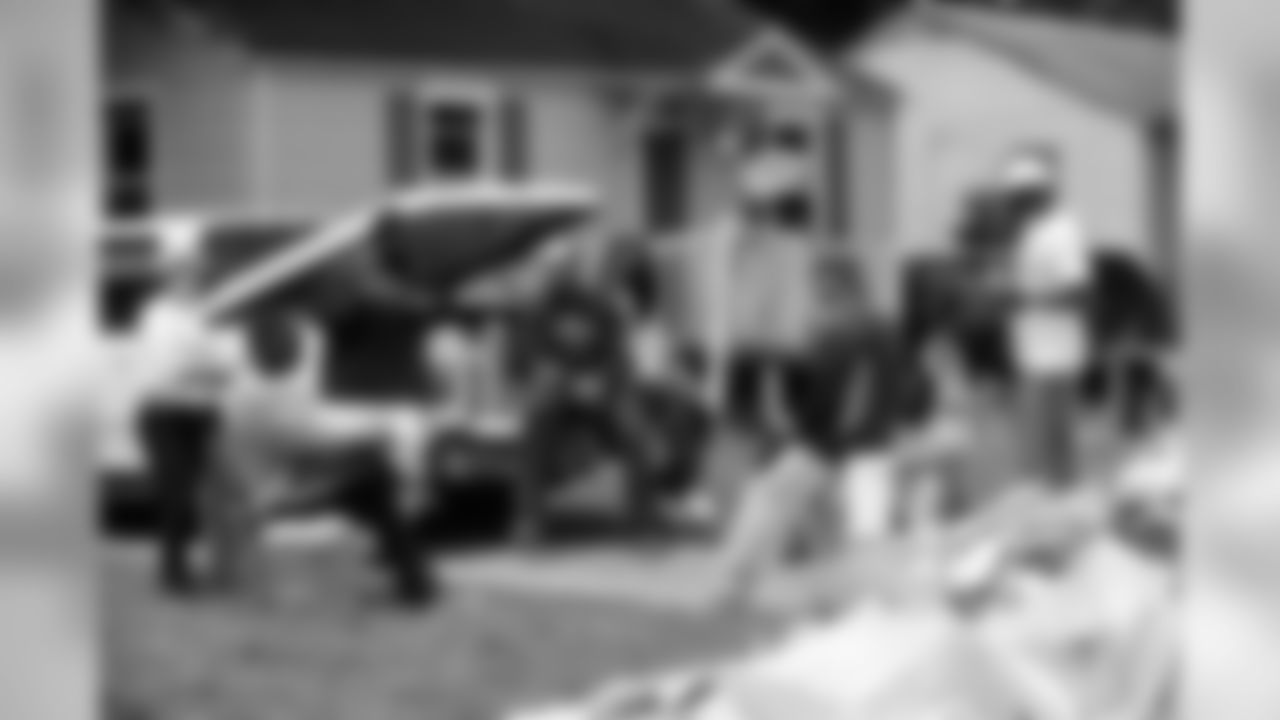 Tennessee Titans players, coaches and staff assist in cleanup efforts and removal of debris from wrecked homes caused from the historical flooding in a west Nashville neighborhood on Wednesday, May 11, 2010.