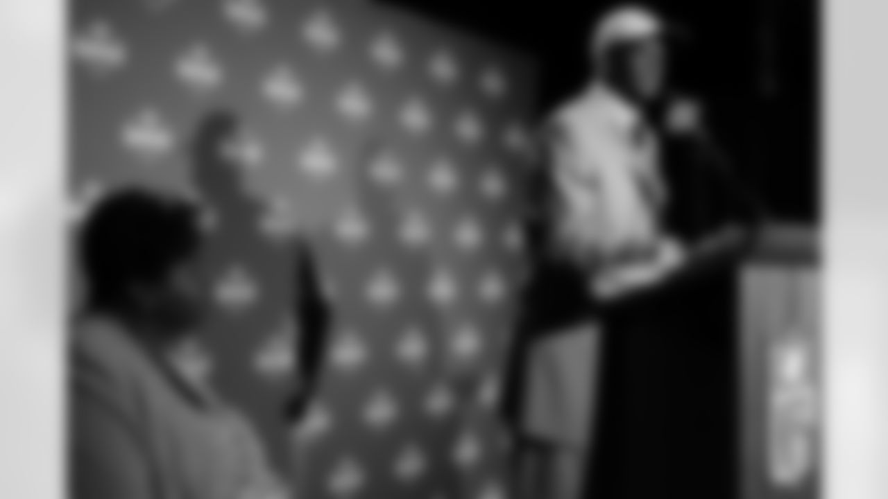 Texas quarterback Vince Young, the first round draft pick of the Tennessee Titans and third overall, speaks to the media as his mom Felicia watches, at the NFL Draft, Saturday, April 29, 2006 at Radio City Music Hall, in New York. (AP Photo/Stephen Chernin)