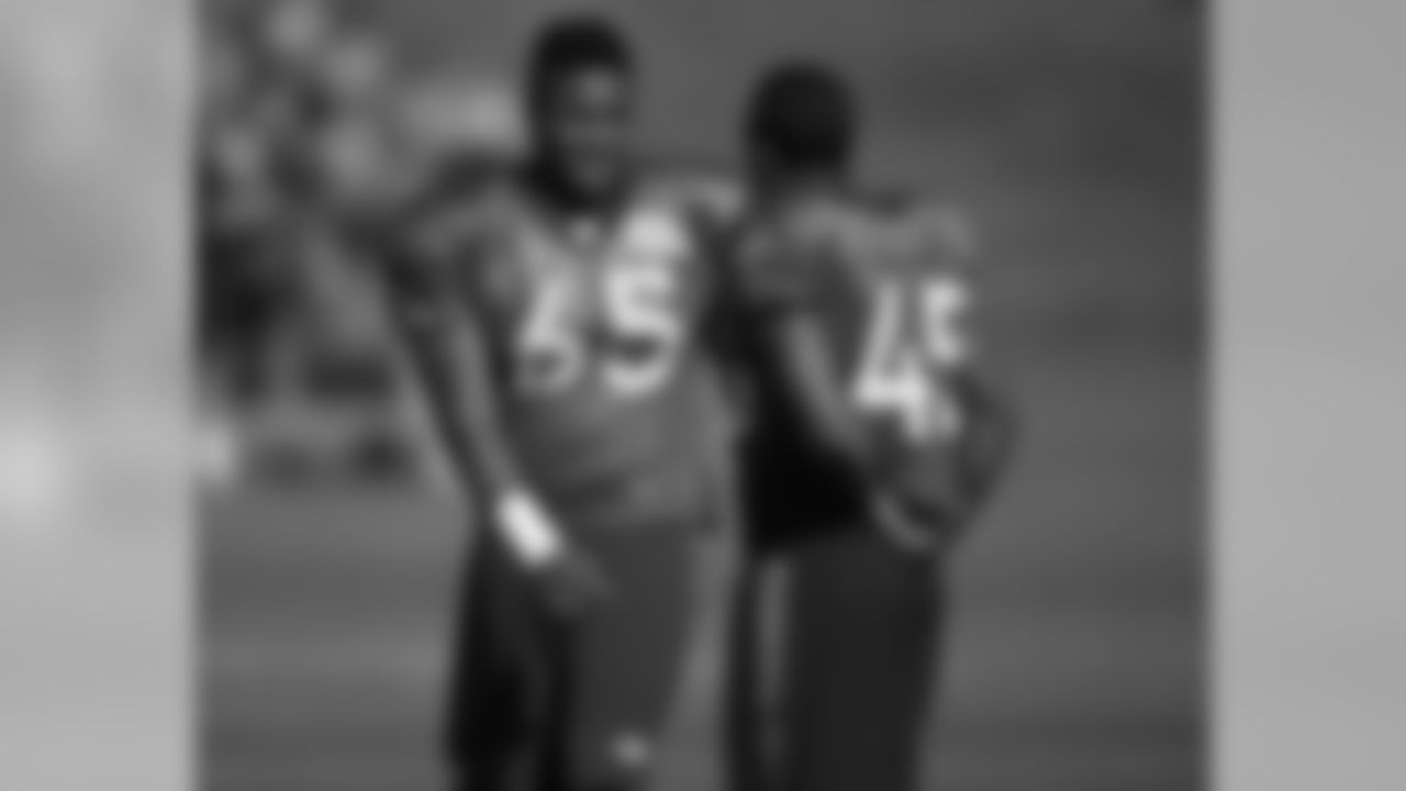 Denver Broncos linebacker Eddie Yarbrough, left, confers with defensive back John Tidwell as they wait to take part in drills during the team's NFL football training camp Saturday, July 30, 2016 in Englewood, Colo. (AP Photo/David Zalubowski)
