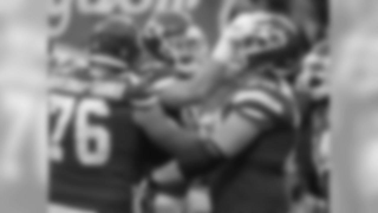 Kansas City Chiefs tight end Travis Kelce, center, celebrates his touchdown between offensive linemen Laurent Duvernay-Tardif (76) and Bryan Witzmann (70) during the first half of an NFL wild-card playoff football game against the Tennessee Titans in Kansas City, Mo., Saturday, Jan. 6, 2018. (AP Photo/Charlie Riedel)