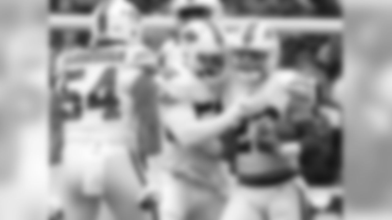 Buffalo Bills safety Micah Hyde (23) celebrates his interception with defensive end Ryan Davis (56) and defensive end Eddie Yarbrough (54)during the second half of an NFL football game against the Oakland Raiders, Sunday, Oct. 29, 2017, in Orchard Park, N.Y. Buffalo beat Oakland 34-14. (AP Photo/Adrian Kraus)