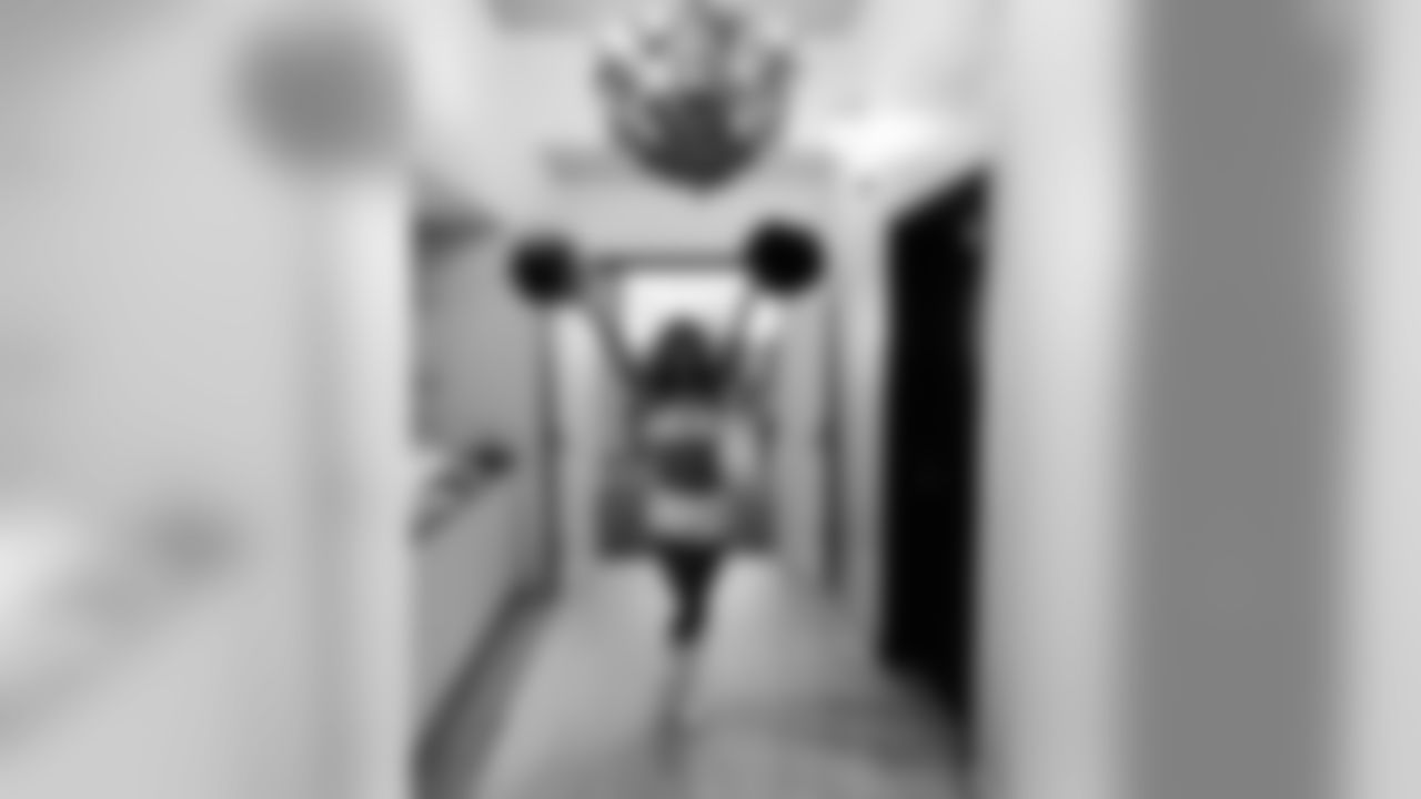 Here's a picture of me in our new locker room, wearing our new costume, and standing under our chandelier. Yup! You heard me right-- we have a purple chandelier in our locker room!!!