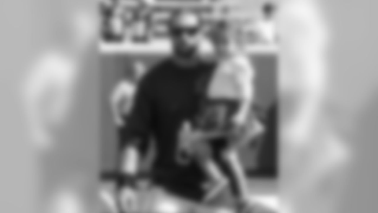 Minnesota Vikings defensive end Brian Robison carries his daughter before an NFL football game against the Atlanta Falcons, Sunday, Sept. 28, 2014, in Minneapolis. (AP Photo/Ann Heisenfelt)