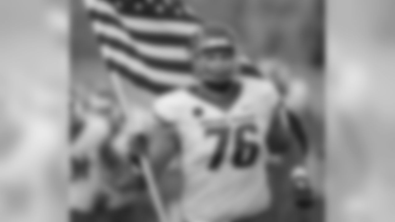 Boise State offensive lineman Ezra Cleveland carries out a United States flag as the team takes the field to face Air Force in an NCAA college football game Saturday, Oct. 27, 2018, at Air Force Academy, Colo. (AP Photo/David Zalubowski)