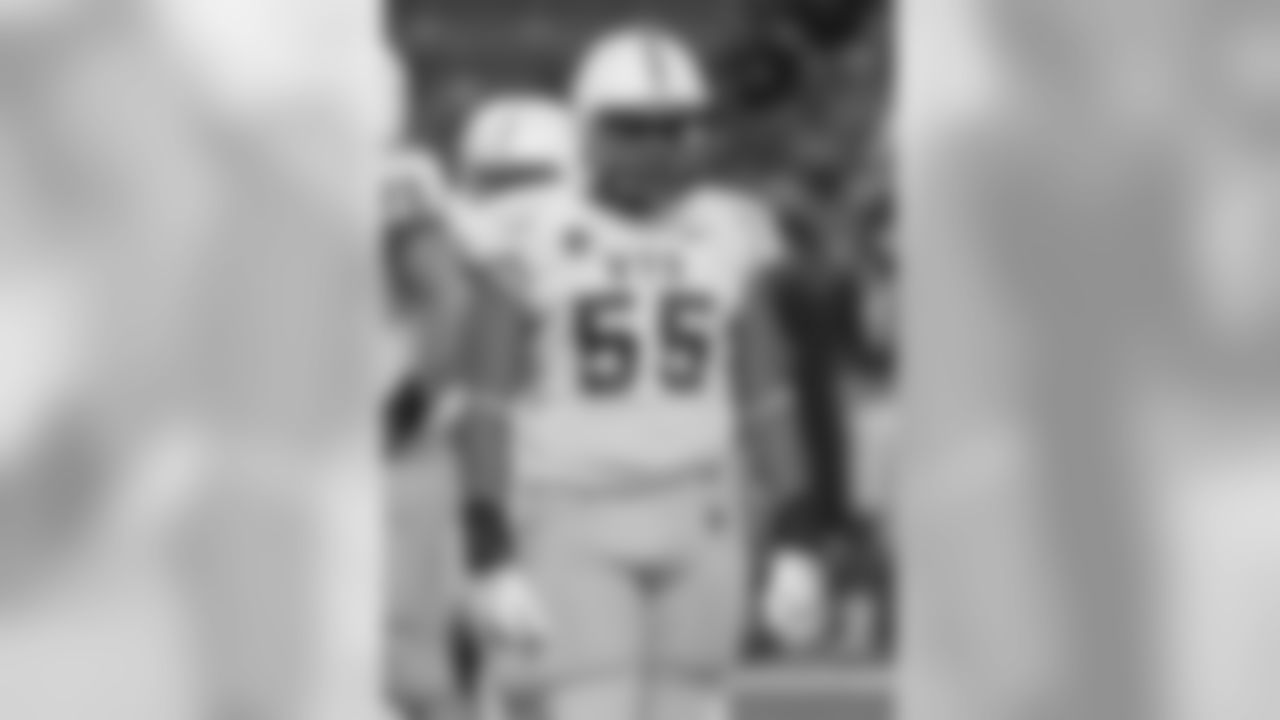 Wyoming defensive end Eddie Yarbrough (55) looks over to the sidelines waiting for his coaches to call the next defensive play in the third quarter of an NCAA college football game, Saturday, Oct. 11, 2014, in Honolulu. (AP Photo/Eugene Tanner)