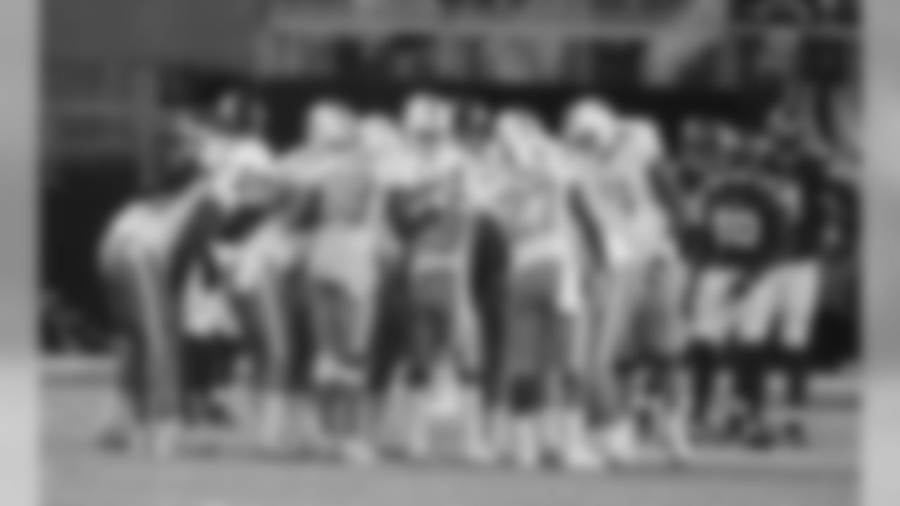 Miami Dolphins players stand in the huddle during the first half of an NFL preseason football game against the Minnesota Vikings, Thursday, Aug. 31, 2017, in Minneapolis. (AP Photo/Jim Mone)
