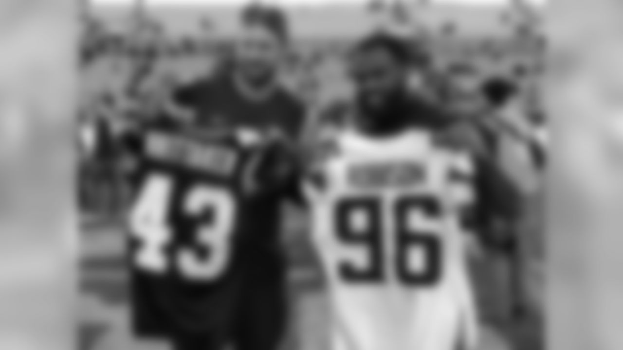 Minnesota Vikings defensive end Brian Robison (left) and Carolina Panthers running back Fozzy Whittaker (43) pose for a photo after a jersey swap following an NFL football game on Sunday, Dec. 10, 2017, in Charlotte, N.C. (NFL Photos via AP)