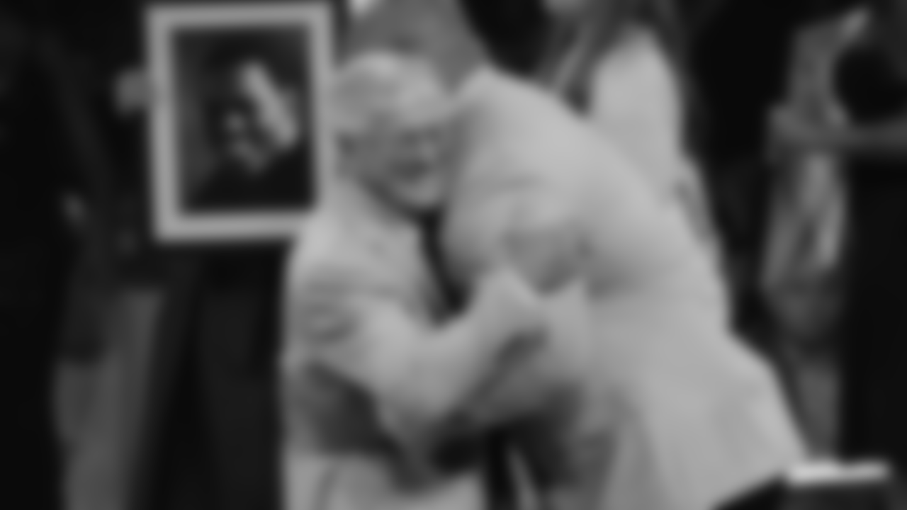 Dick Vermeil embraces former New England Patriots defensive lineman Richard Seymour.