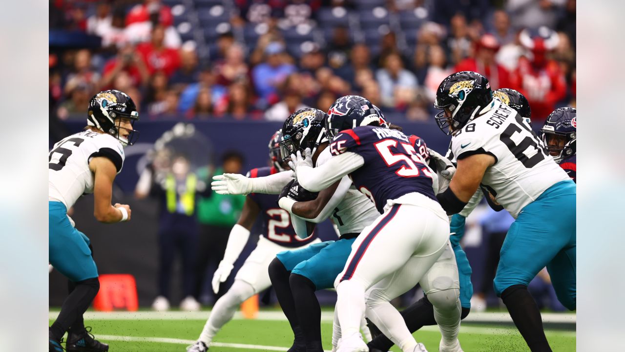 Houston, Texas, USA. 1st Jan, 2023. Jacksonville Jaguars running back  JaMycal Hasty (22) carries the ball while being tackled by Houston Texans  linebacker Christian Harris (48) during the game between the Houston