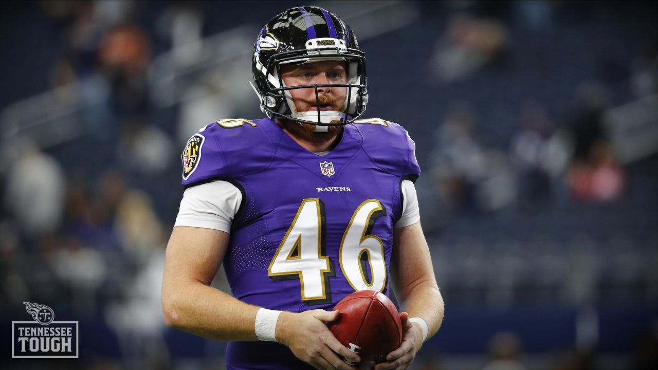 Baltimore Ravens long snapper Morgan Cox (46) waits to take the field while  holding a flag as part of the team's Salute to Service prior to an NFL  football game against the