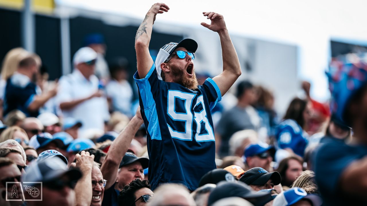 Tennessee Titans vs. Indianapolis Colts. Fans support on NFL Game.  Silhouette of supporters, big screen with two rivals in background. Stock  Photo