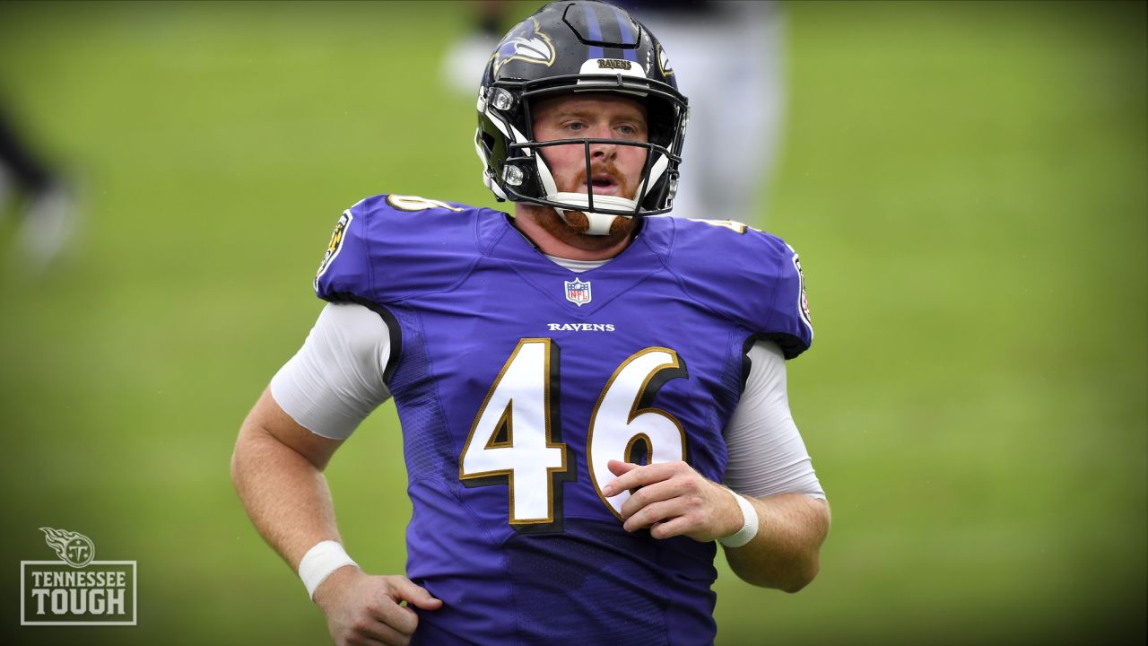 Baltimore Ravens long snapper Morgan Cox (46) waits to take the field while  holding a flag as part of the team's Salute to Service prior to an NFL  football game against the