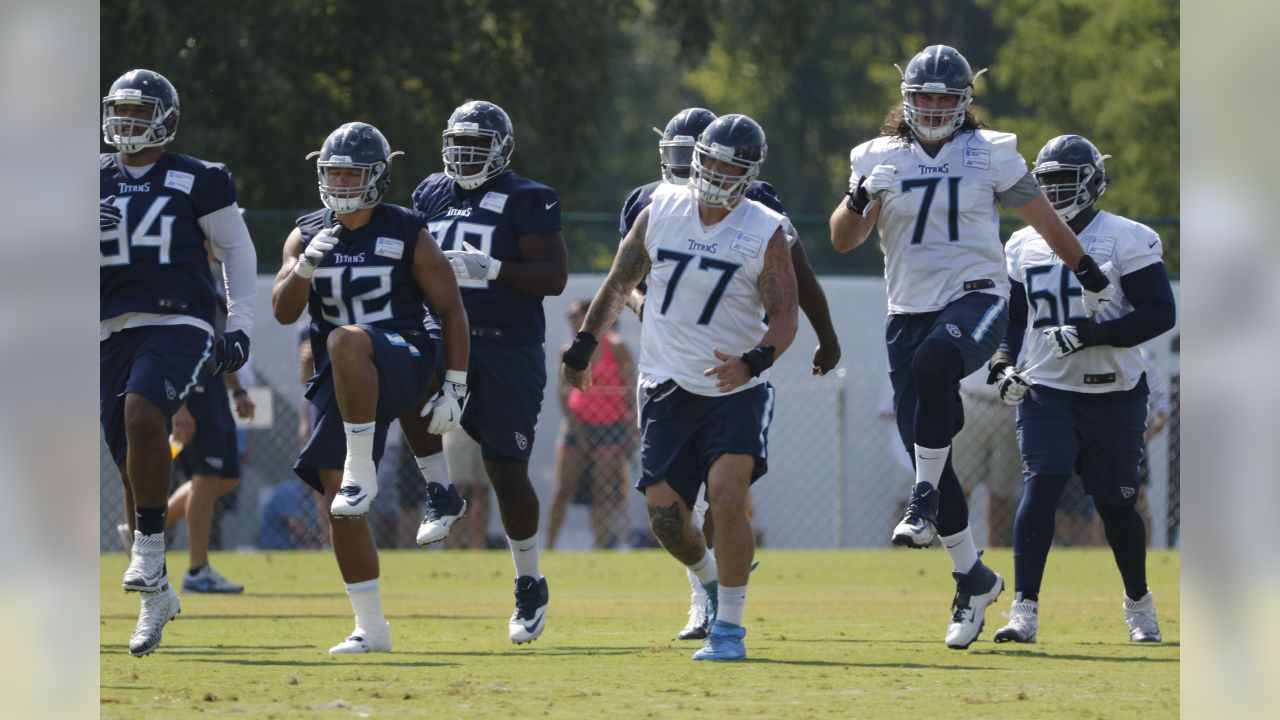 Tennessee Titans offensive tackle Taylor Lewan carries his daughter, Wynne,  1, as he leaves the field following the first day of practice at NFL  football training camp Thursday, July 26, 2018, in