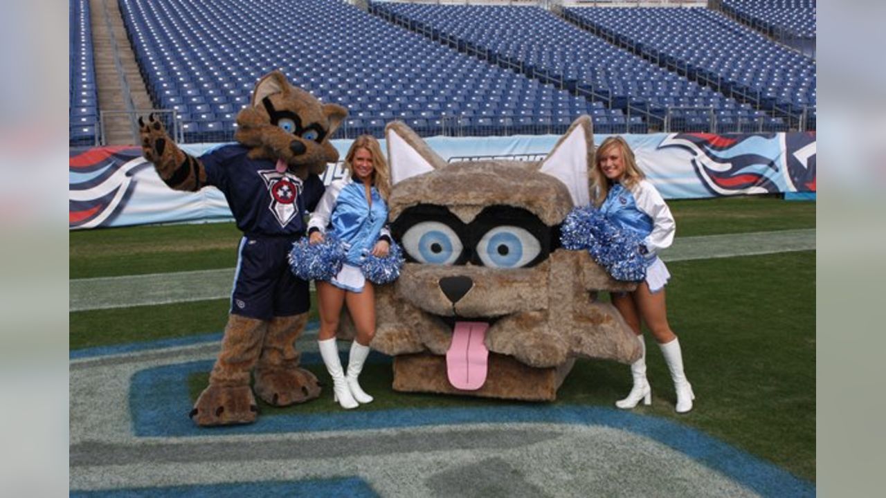 A flag runner with the Tennessee Titans mascot after the team scored  against the Oakland Raiders in the first half of their game at the Nissan  Stadium in Nashville, Tenn., Sunday, Sept.