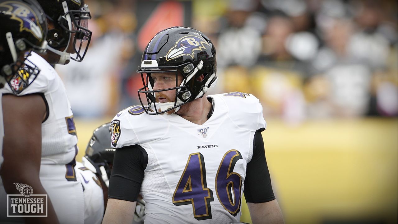 Baltimore Ravens long snapper Morgan Cox (46) waits to take the field while  holding a flag as part of the team's Salute to Service prior to an NFL  football game against the