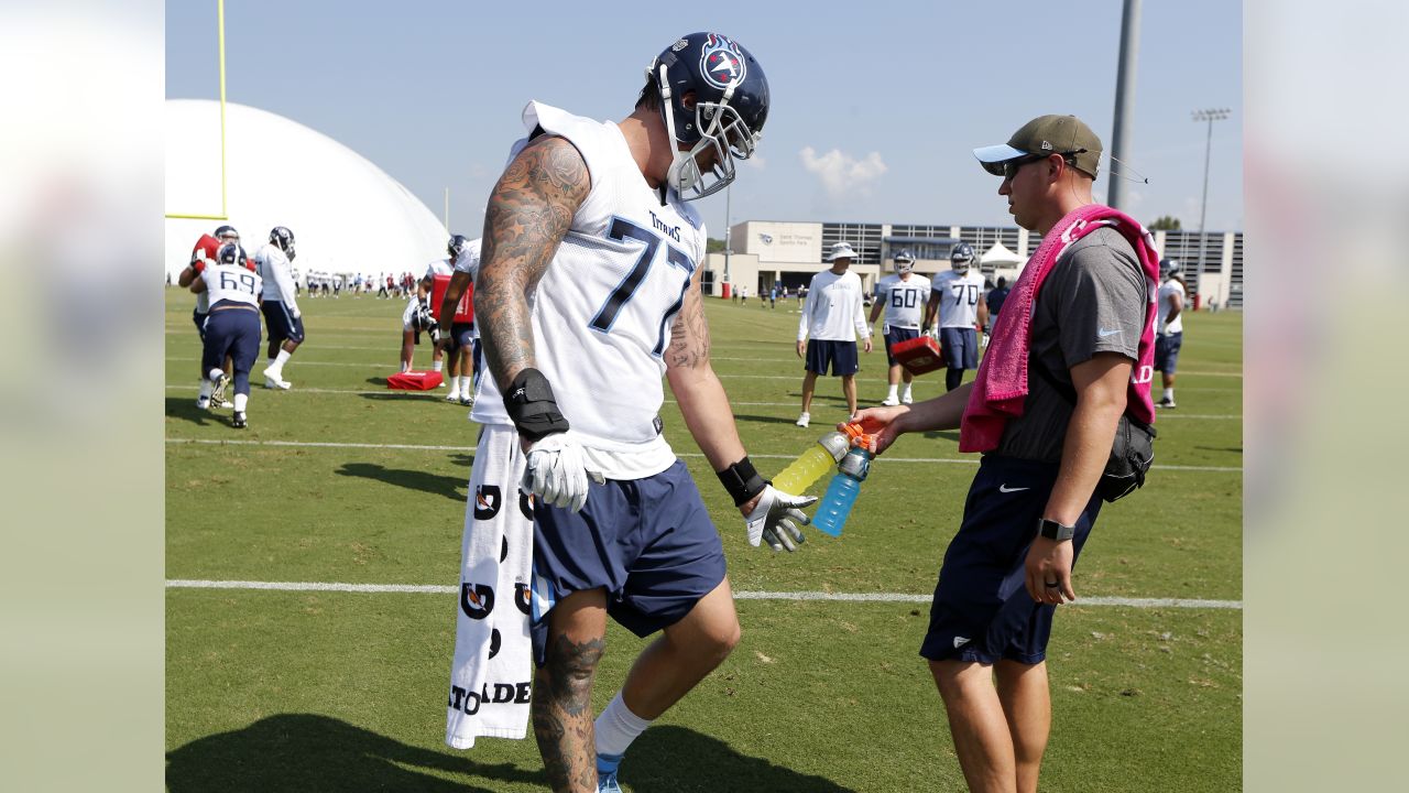 Tennessee Titans tackle Taylor Lewan (77) warms up during training camp at  the NFL football team's practice facility Wednesday, July 27, 2022, in  Nashville, Tenn. (AP Photo/Mark Humphrey Stock Photo - Alamy