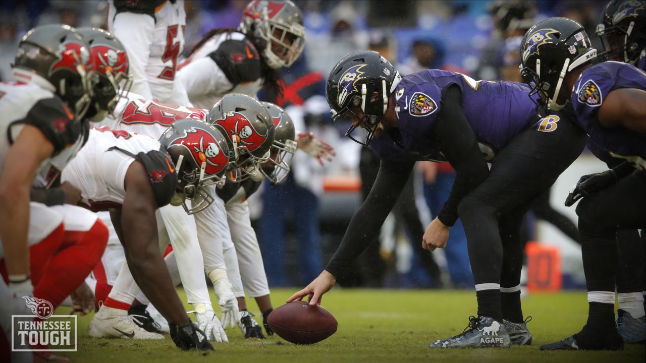 Baltimore Ravens long snapper Morgan Cox (46) waits to take the field while  holding a flag as part of the team's Salute to Service prior to an NFL  football game against the