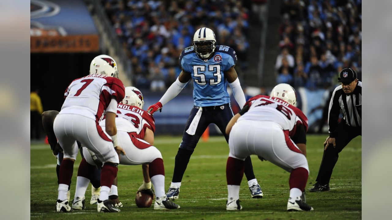 San Diego Chargers' LaDainian Tomlinson (21) is tackled by Tennessee  Titans' Stephen Tulloch, center, and Keith Bulluck, right, on a two-yard  run during the second quarter of their AFC wild-card game Sunday