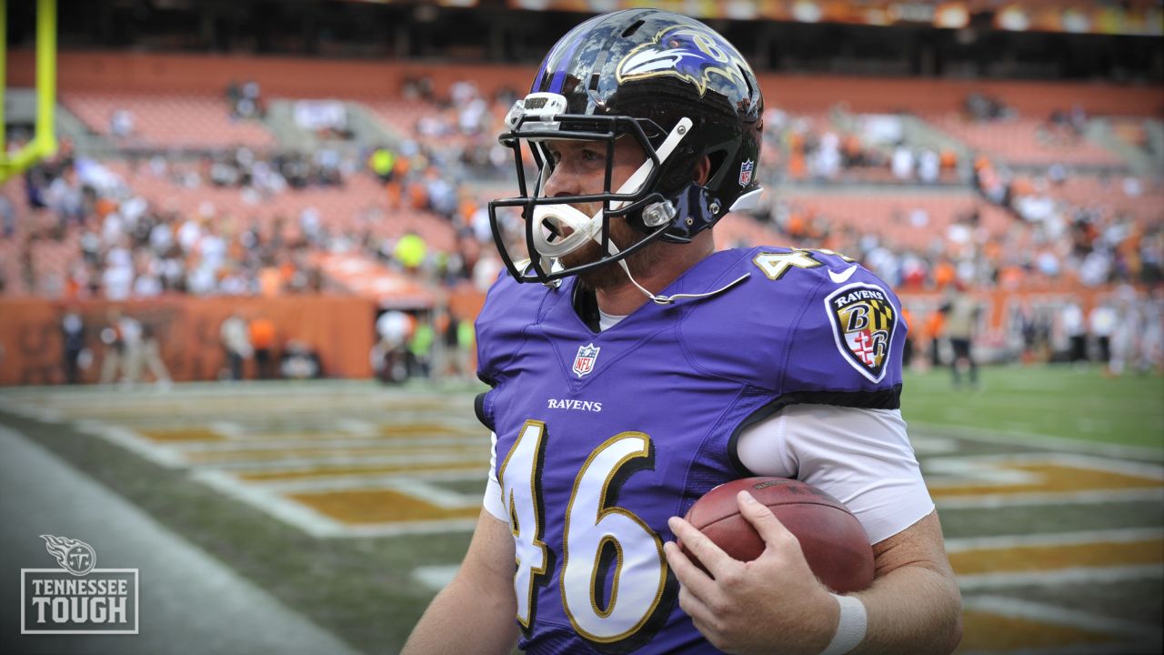 Baltimore Ravens long snapper Morgan Cox (46) waits to take the field while  holding a flag as part of the team's Salute to Service prior to an NFL  football game against the