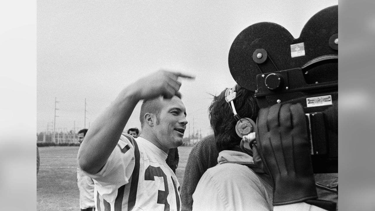 Minnesota Vikings running back Bill Brown, left, has his hand out to  congratulate quarterback Joe Kapp after Kapp scored his first touchdown to  defeat of the Cleveland Browns, 27-7 for the NFL