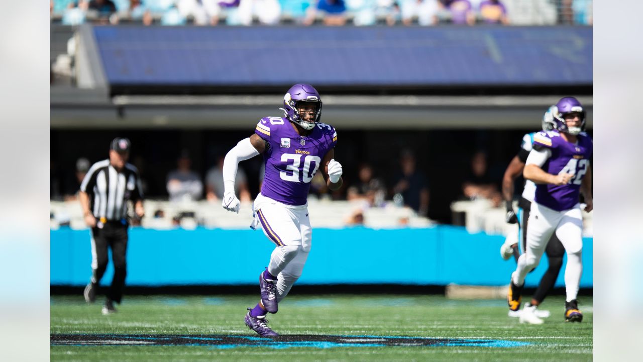 Minnesota Vikings fullback C.J. Ham (30) runs with the ball during the  first half of an NFL football game against the Chicago Bears, Sunday, Jan.  8, 2023, in Chicago. (AP Photo/Kamil Krzaczynski