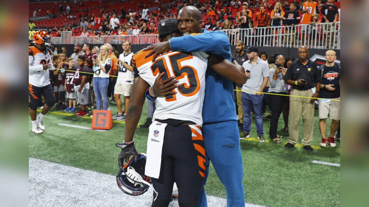 Former Cincinnati Bengals wide receiver Chad Johnson hugs Cincinnati Bengals wide receiver John Ross (15) prior to a game against the Atlanta Falcons, Sunday, Sept. 30, 2018 in Atlanta. Cincinnati won 37-36. (Logan Bowles via AP)