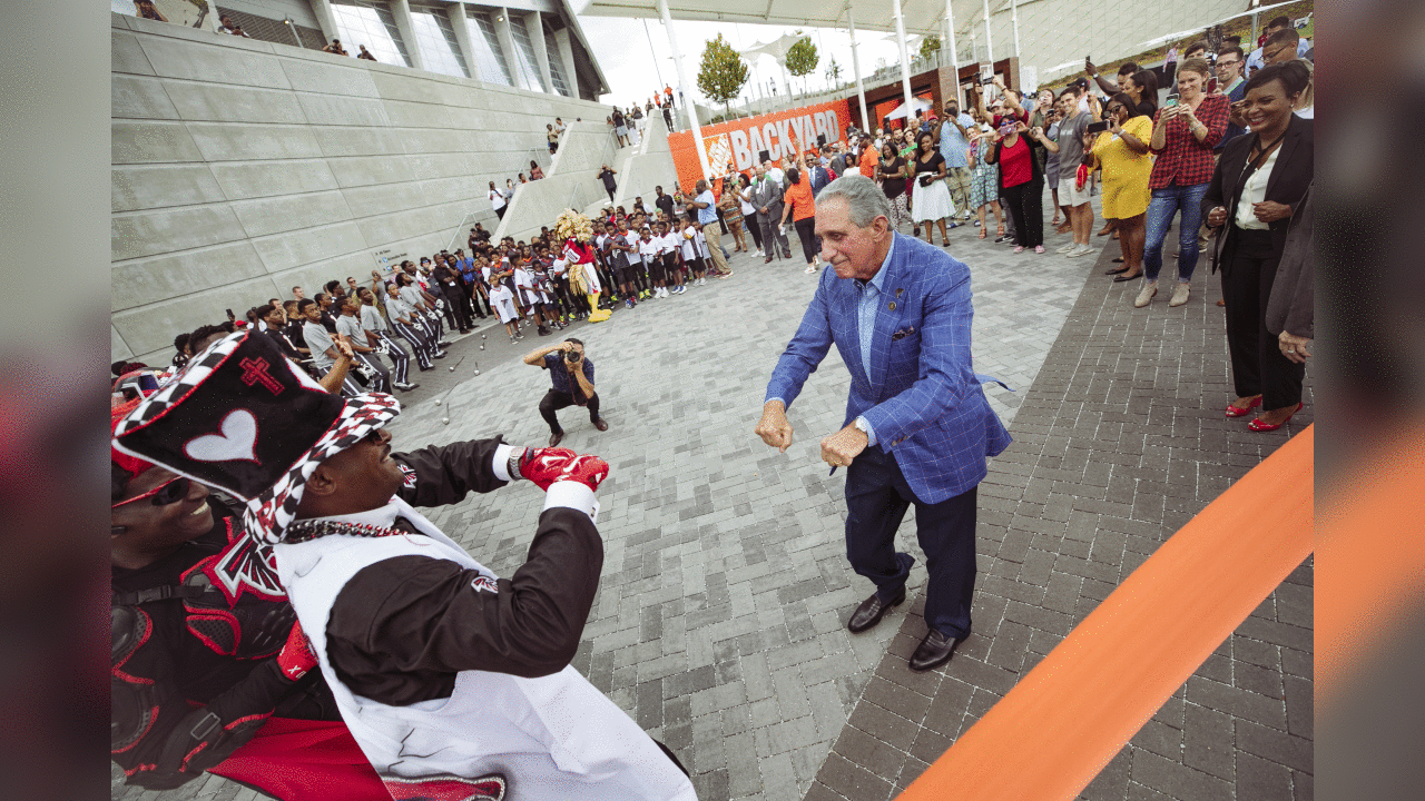 Arthur Blank dances with fans prior to the ribbon cutting at the Home Depot Backyard