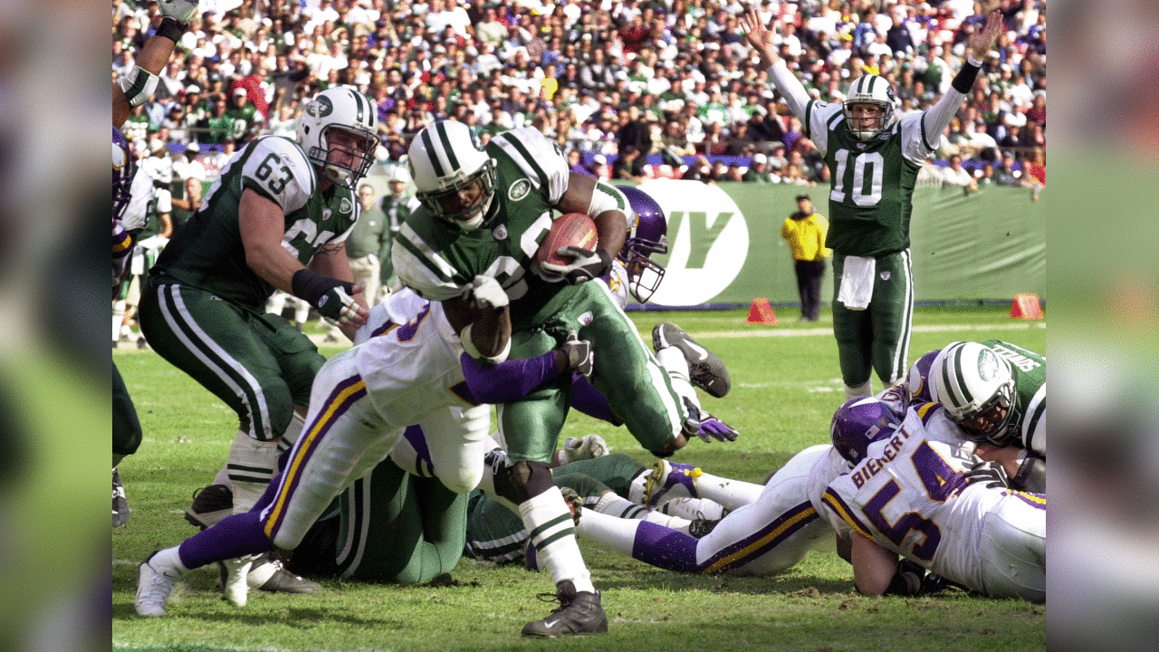 New York Jets Curtis Martin rushes for a third quarter touchdown against the Minnesota Vikings Sunday, Oct. 20, 2002 in East Rutherford, N.J. Quarterback Chad Pennington (10) signals the score. The Jets won 20-7. (AP Photo/Mark Lennihan)