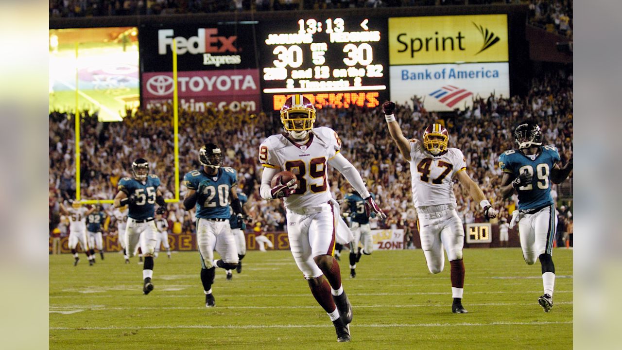 Washington Redskins wide receiver Santana Moss (89) races to the end zone on a 68-yard reception for a touchdown to win the game 36-30 against the Jacksonville Jaguars during overtime of a NFL football game, Sunday, Oct. 1, 2006, in Landover, Md. Redskins tight end Chris Cooely (47) celebrates as Jaguars linebacker Nick Greisen (55), safety Donovin Darius (20) and cornerback Brian Williams (29) pursue.(AP Photo/Nick Wass)