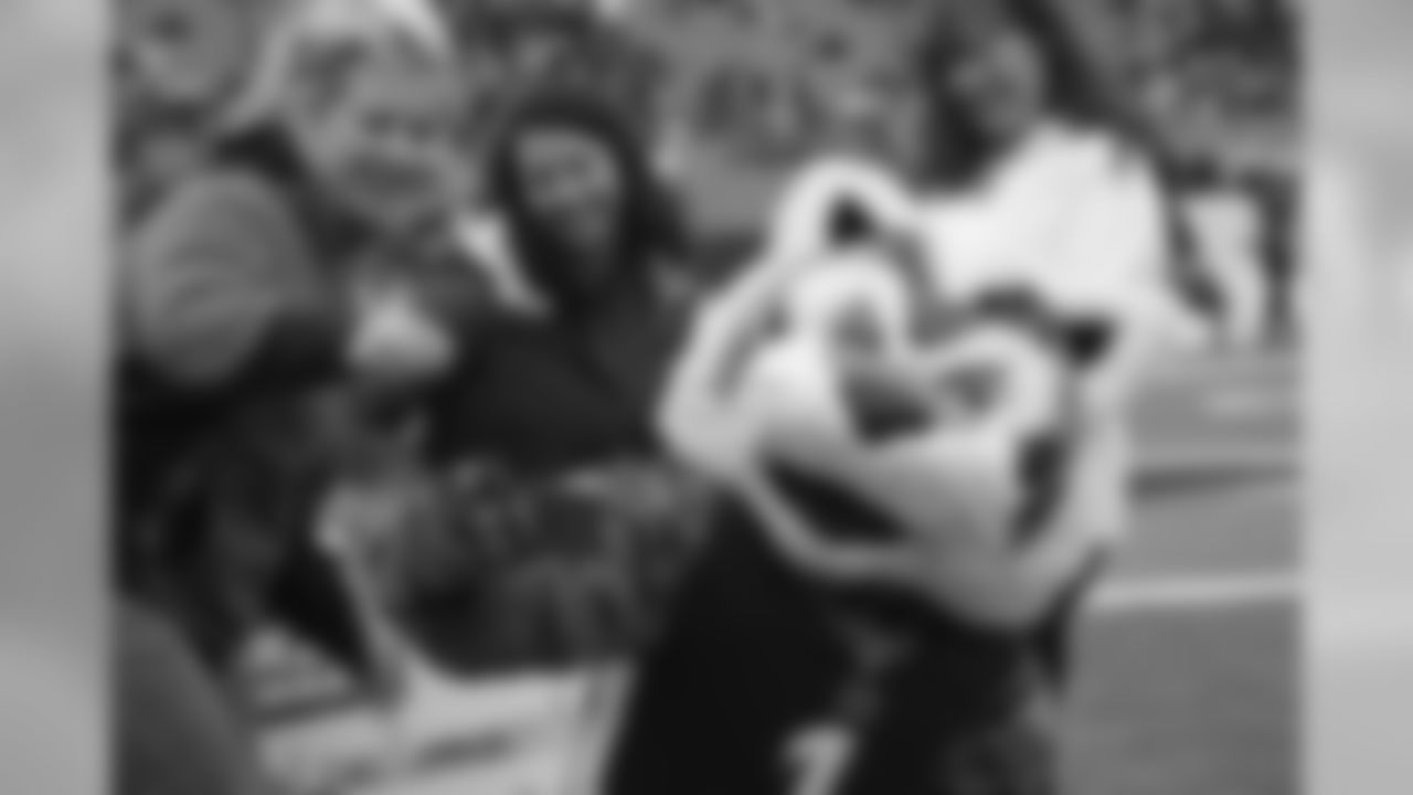 Bengals mascot Who Dey takes a selfie with fans during a check presentation prior to the game against the Oakland Raiders.