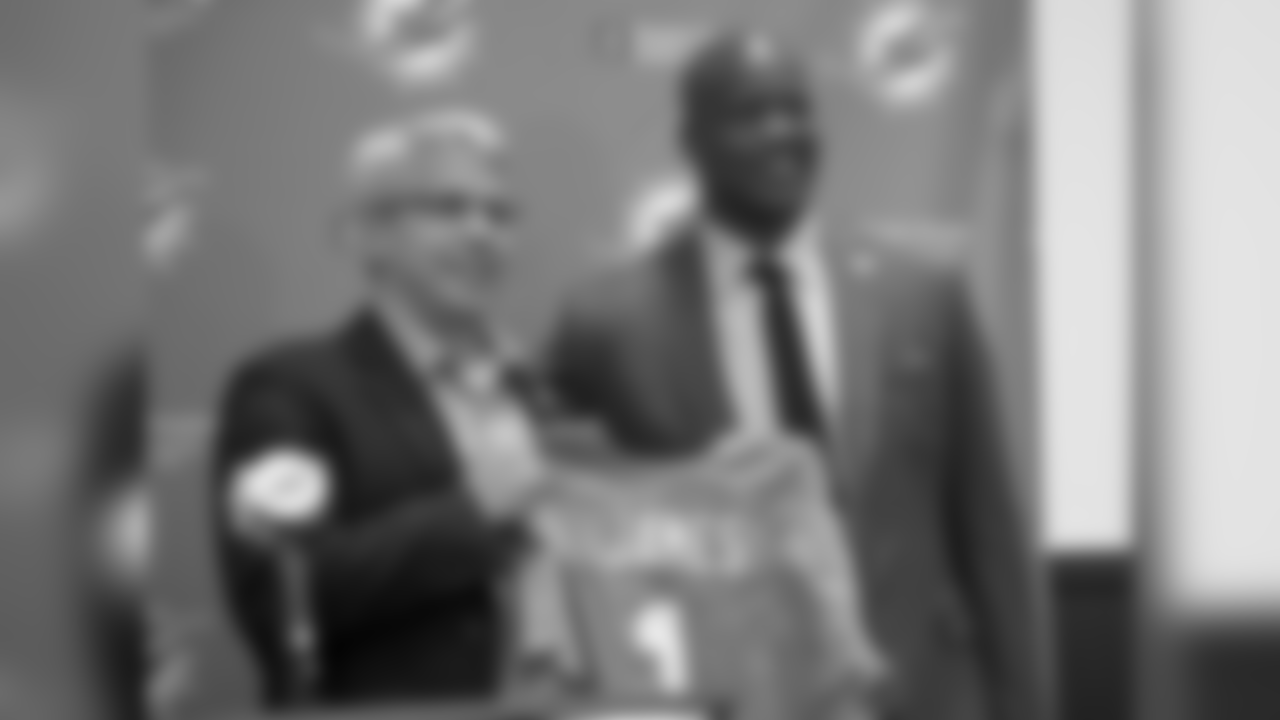 Miami Dolphins general manager Dennis Hickey, left, and first round draft pick Ja'Wuan James pose for photos with James' new jersey during an NFL football news conference Friday, May 9, 2014, in Davie, Fla. The Dolphins selected James with the 19th overall pick in Thursday's draft. (AP Photo/J Pat Carter)