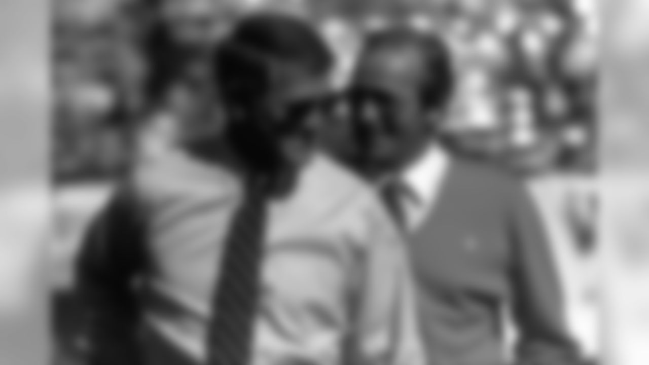 Coach Dan Reeves and owner Pat Bowlen talk during a November 1985 game.
