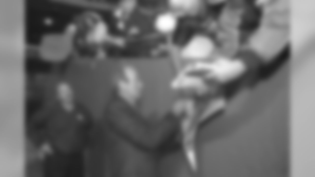 Pat Bowlen signs an autograph for a Broncos fan in Kansas City against the Kansas City Chiefs at Arrowhead Stadium in Kansas City, MO on November 16, 1998.