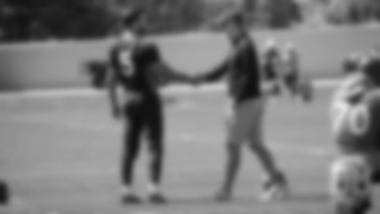 Joe Flacco greets former Broncos quarterback Peyton Manning during the Broncos' practice on the eight day of their OTAs on May 30, 2019.