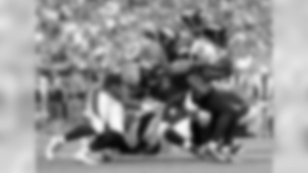 The Broncos defense converges on Ravens RB Justin Forsett (29)