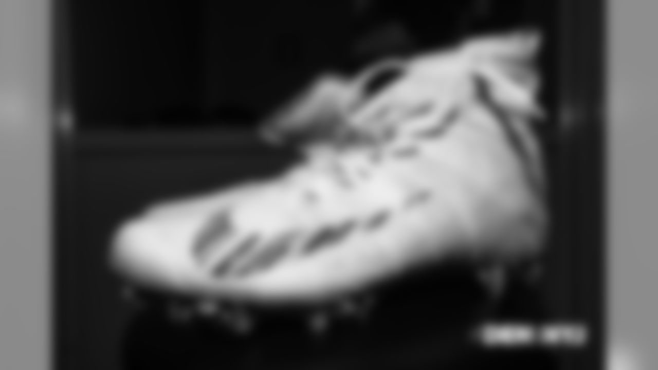A pair of Crucial Catch Nike cleats in the locker room pregame before the Broncos' Week 5 game against the New York Jets at MetLife Stadium on October 7, 2018.
