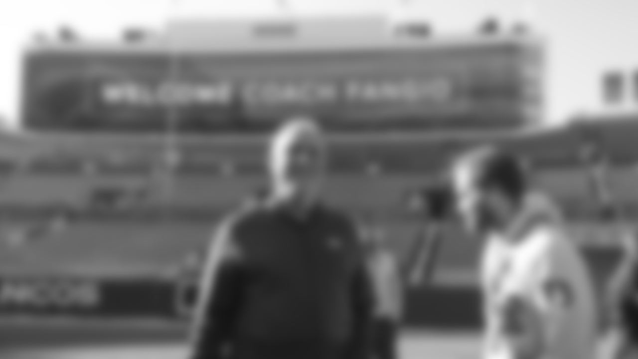 Head Coach Vic Fangio shares a laugh with a staff member at a meet-and-greet visit with team employees at Broncos Stadium at Mile High on March 19, 2019.