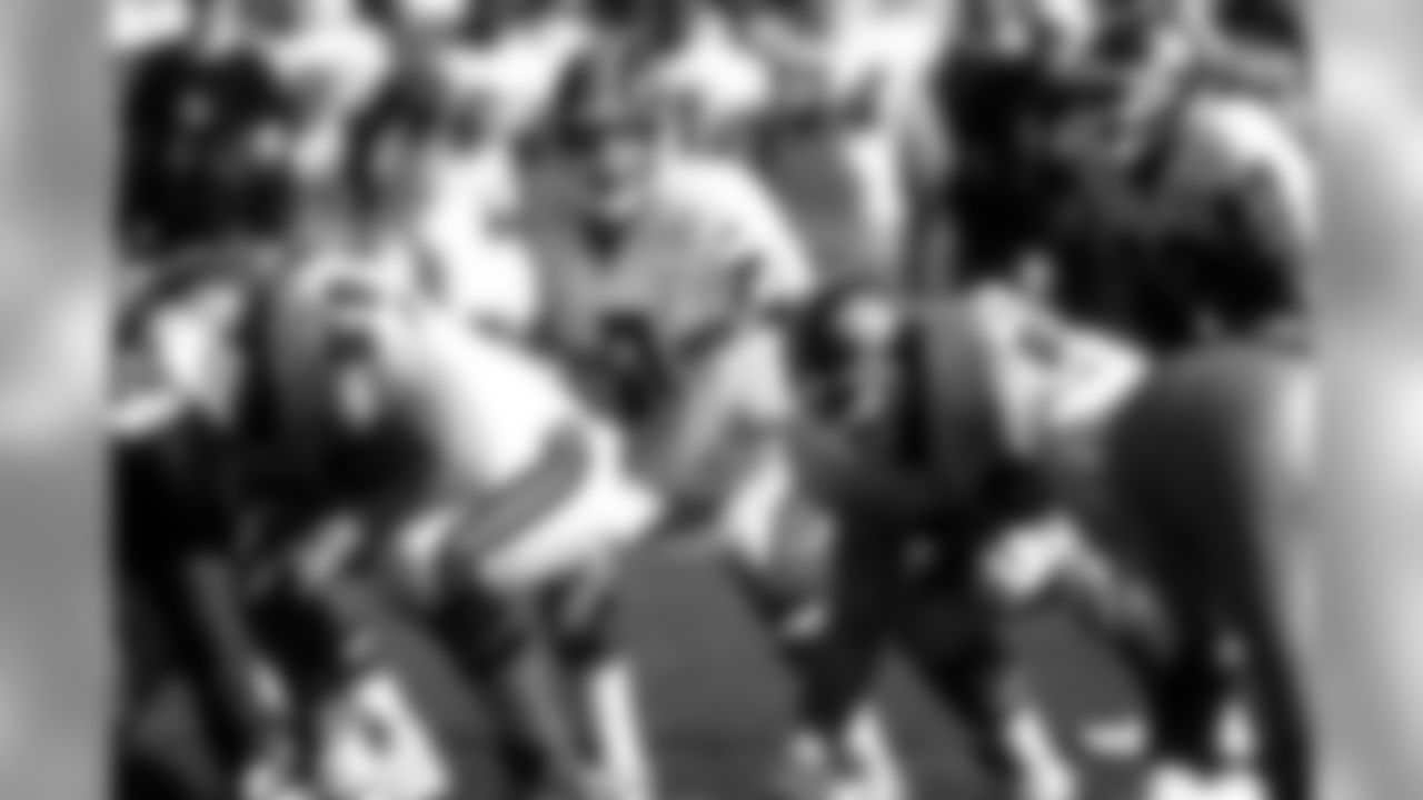 Quarterback John Elway takes a snap during a December 24, 1995 win (31-28) against the Oakland Raiders.