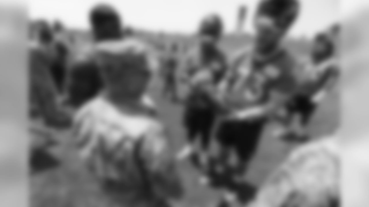 Tackle Andreas Knappe (73) and other offensive linemen meet military members of the Colorado Air National Guard and the U.S. Army after practice on June 12, 2018. The meet-and-greet was part of an event hosting servicemen and servicewomen with USAA and the Broncos Womens Organization.