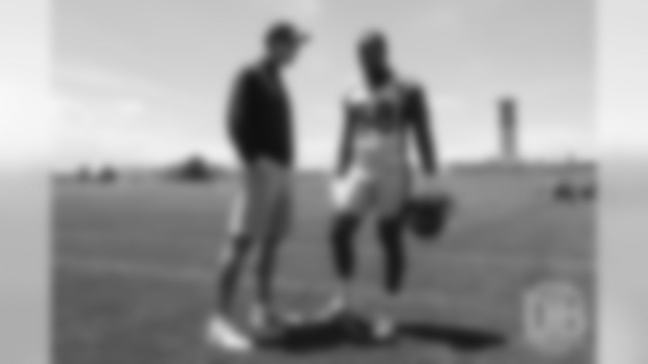 Von Miller talks with former Broncos quarterback Peyton Manning after the Broncos' practice on the eight day of their OTAs on May 30, 2019.