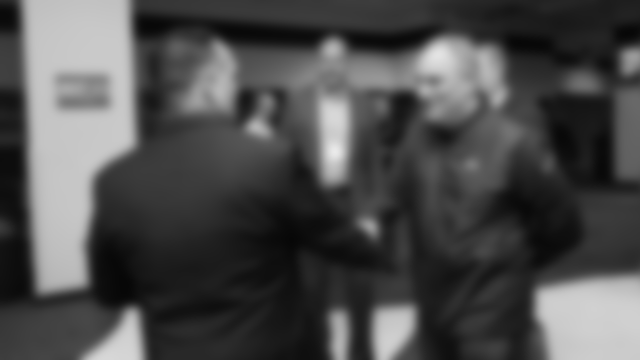 Head Coach Vic Fangio greets Director of Marketing Ted Santiago at a meet-and-greet visit with team employees at Broncos Stadium at Mile High on March 19, 2019.