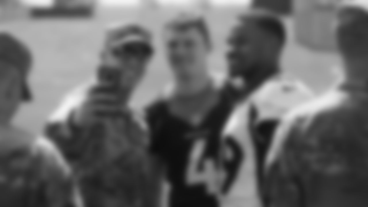Brett Rypien and Malik Reed meet military members who visited and viewed practice as part of a USAA luncheon on June 4, 2019.