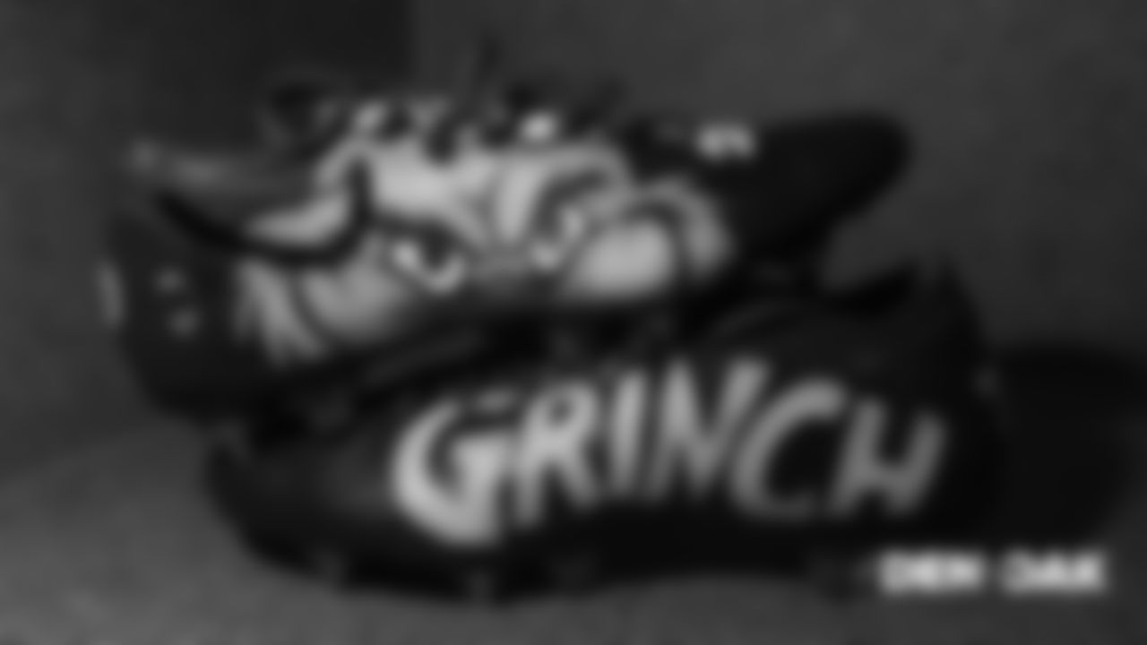 Jamar Taylor's custom "The Grinch" themed cleats in the locker room pregame before the Broncos' Week 16 game against the Oakland Raiders on December 24, 2018.