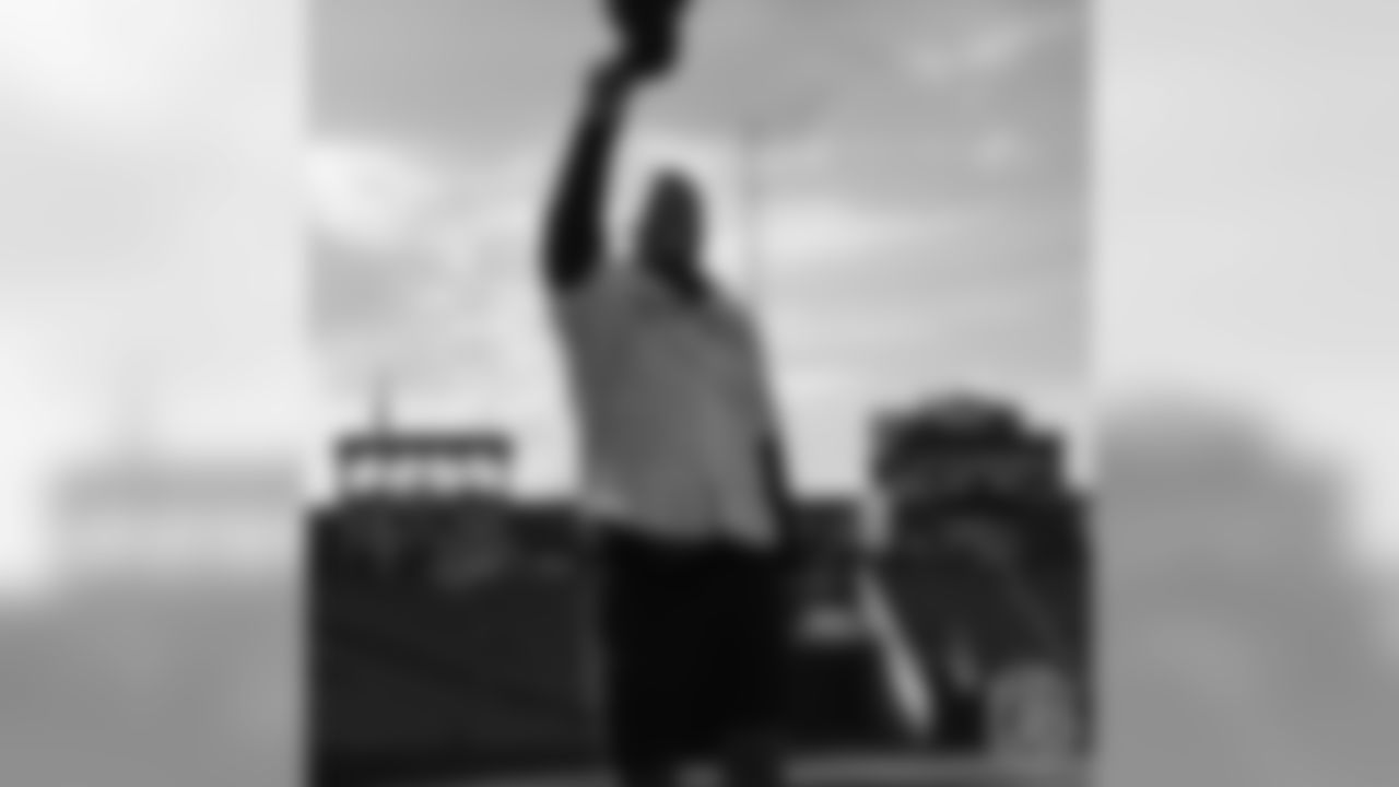 Bradley Chubb raises his hat as he rounds the bases during a visit to the Colorado Rockies' clubhouse at Coors Field on May 29, 2019.