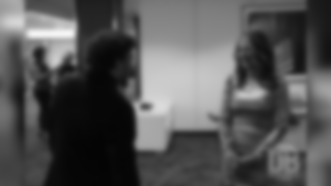 Phillip Lindsay greets Beth Bowlen Wallace before she awaits the knock on the door announcing the Pro Football Hall of Fame's selection of Pat Bowlen for enshrinement in the Class of 2019 on February 2, 2019.