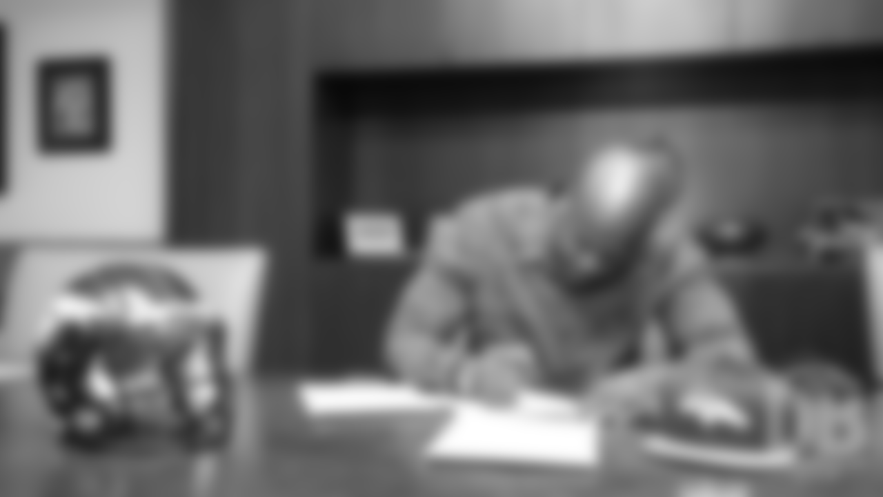 Ja'Wuan James signs his contract as a free agent during his first day as a Bronco at UCHealth Training Center on March 15, 2019.