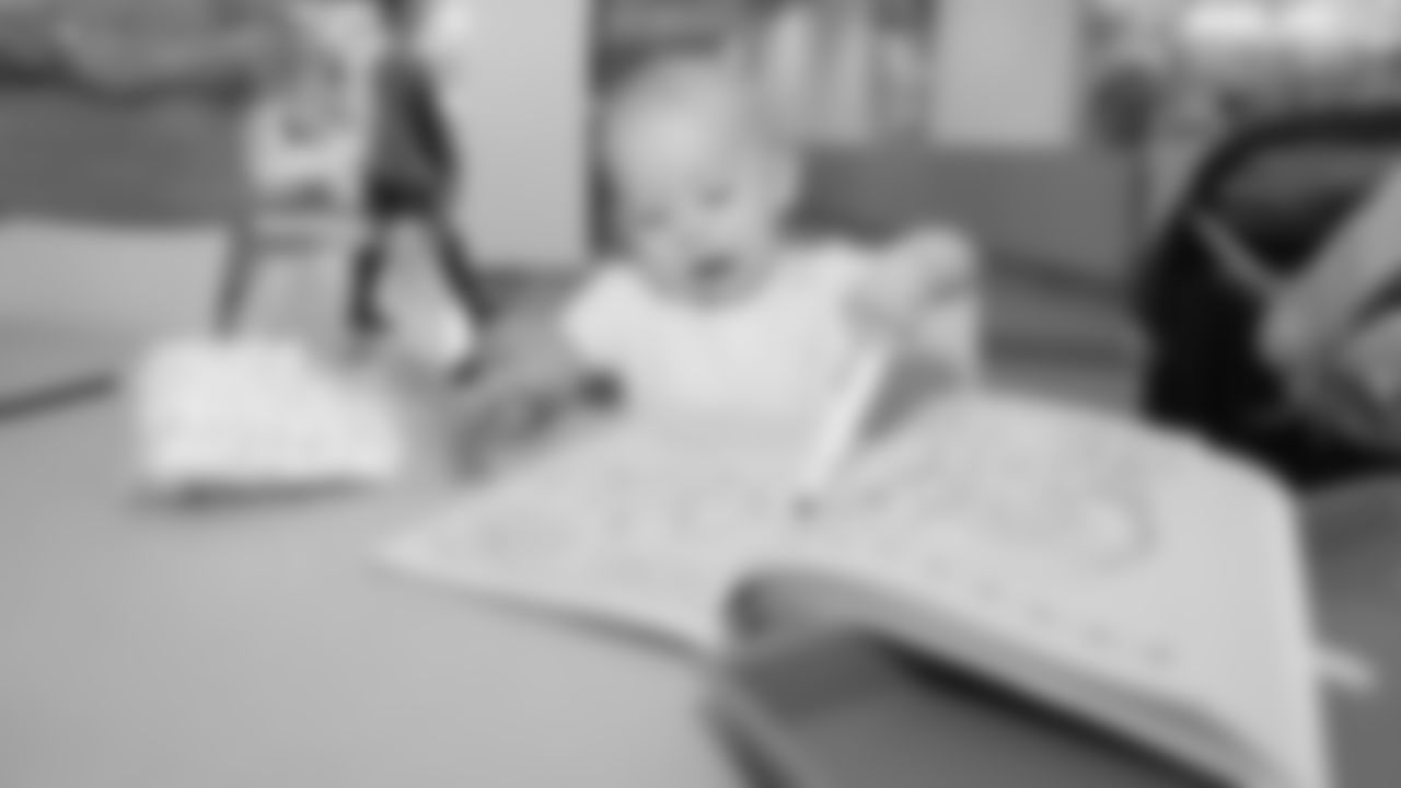 A young infant draws with a marker at the arts and crafts station during the inaugural Denver Day of Service at the Children's Hospital Colorado location on June 7, 2019.