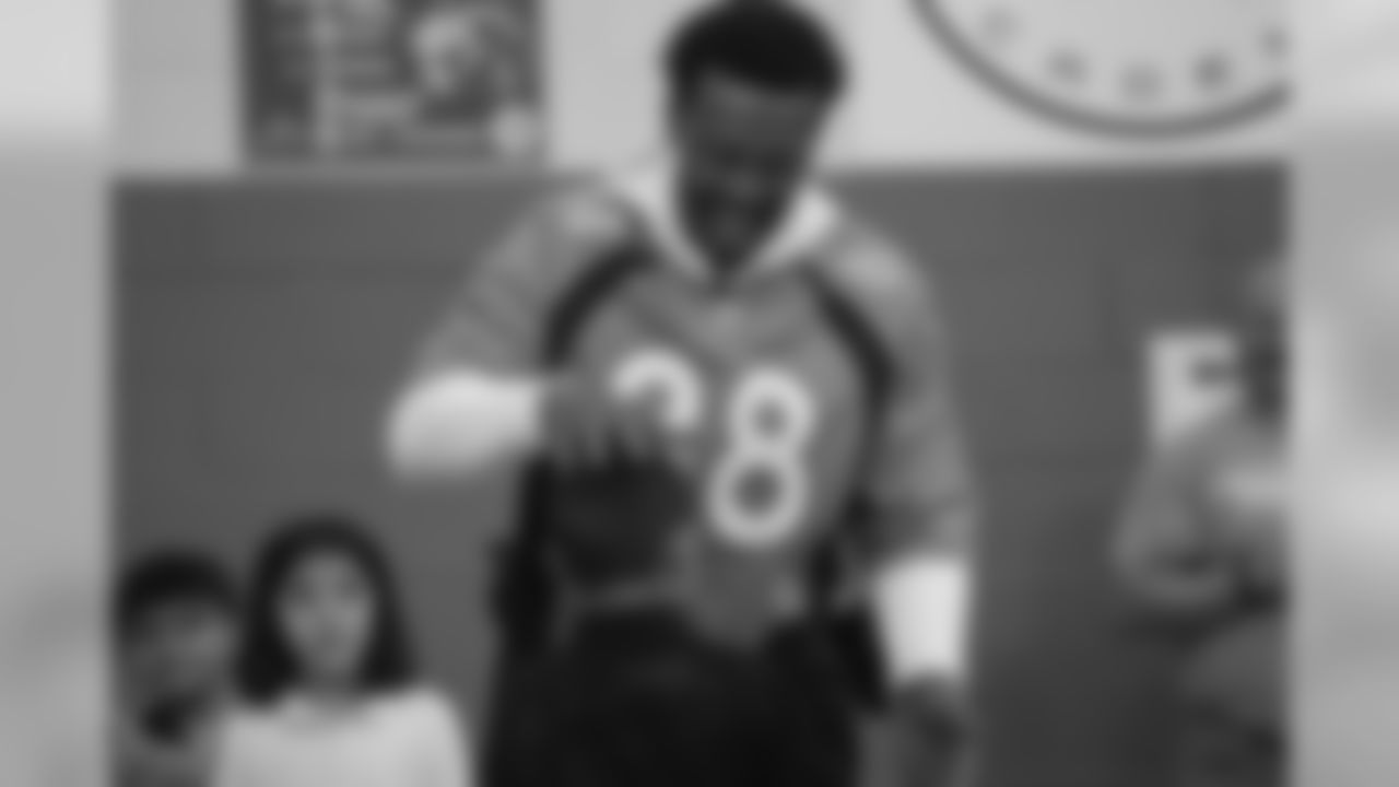 Demaryius Thomas plays rock, paper, scissors at a Playworks recess visit (alongside CarMax volunteers) with first-, second- and third-grade students at Greenwood Academy on October 9, 2018.
